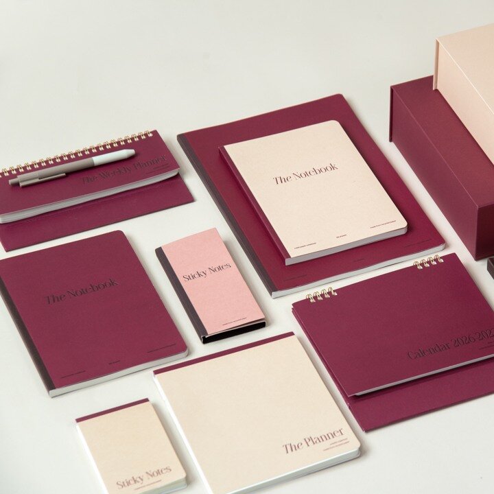 New notebooks and stationery in burgundy and pink tones.