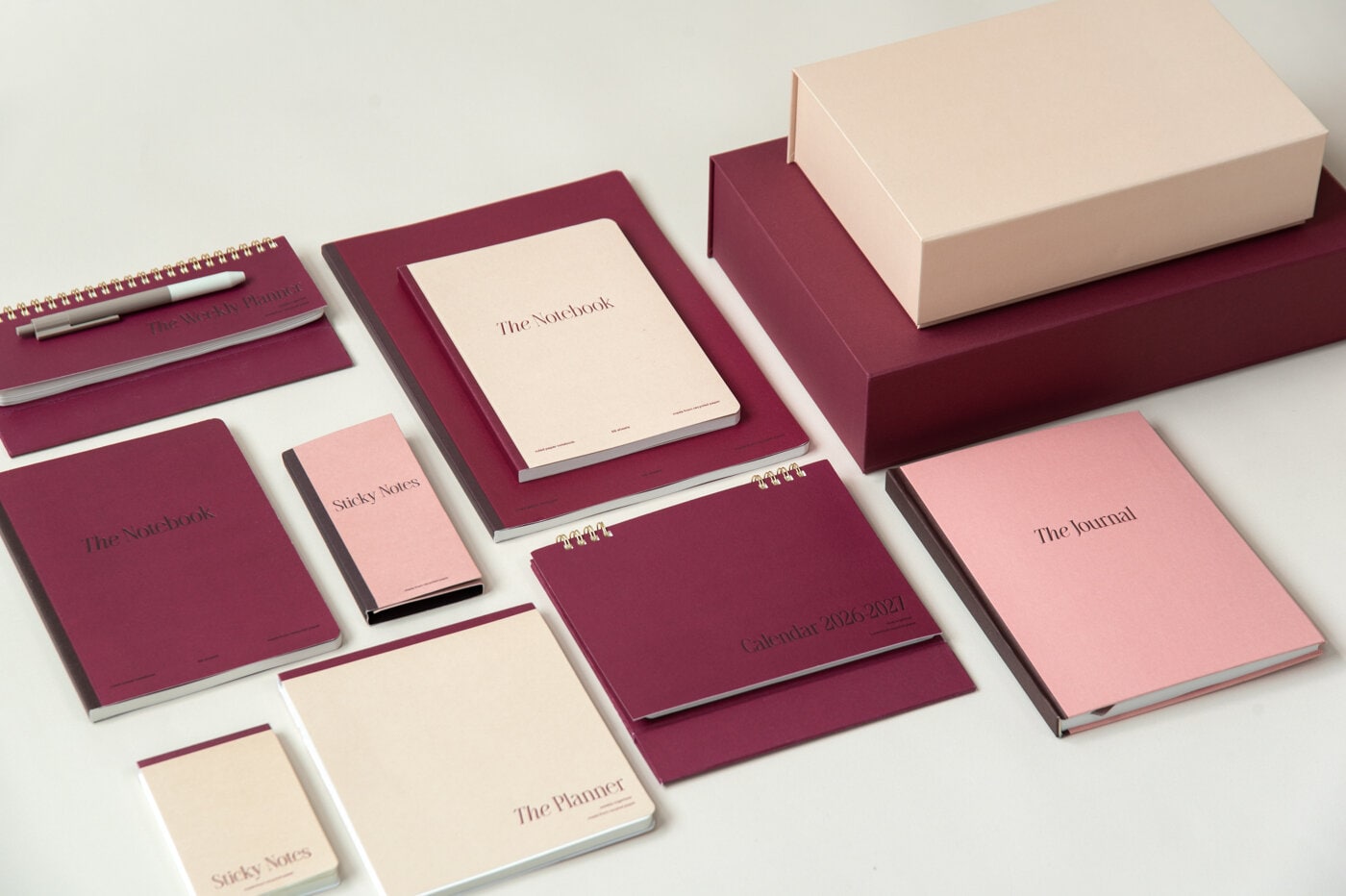 Notebooks and office supply in burgundy and beige colour.