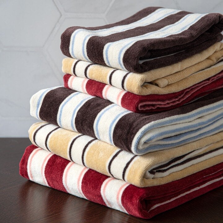 Stacked striped towels in various colours.