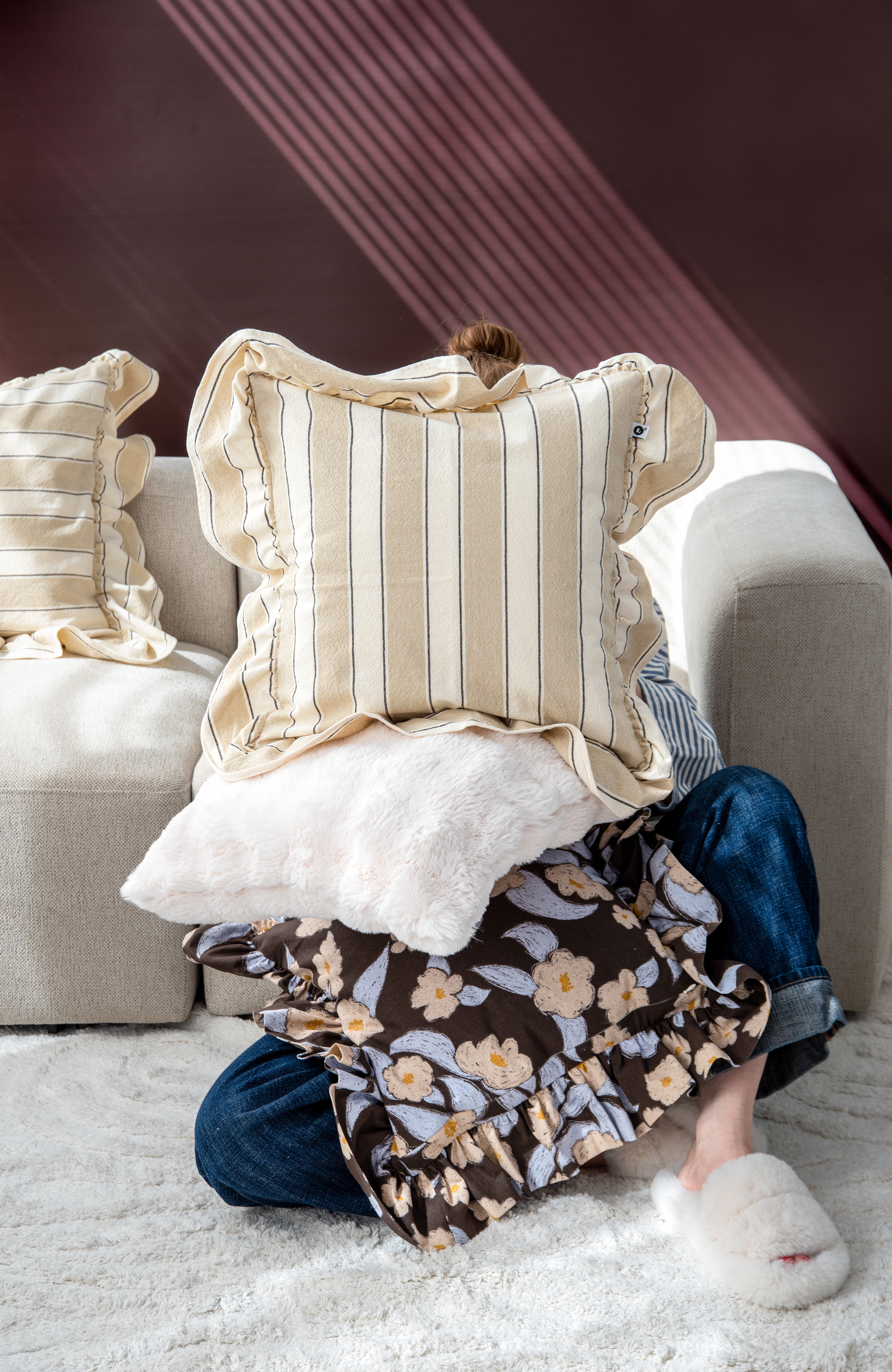 Decorative cushions and textiles styled on a chair.