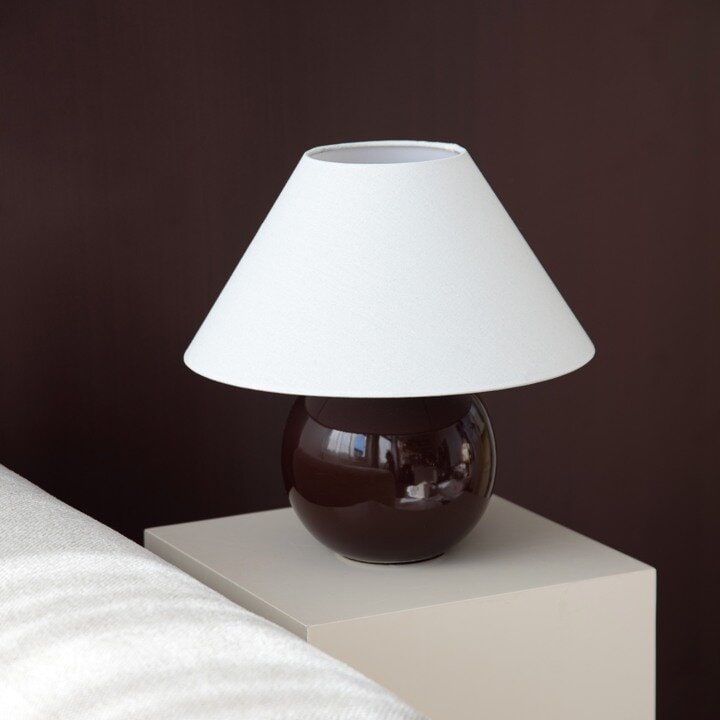Brown table lamp with a white lampshade.