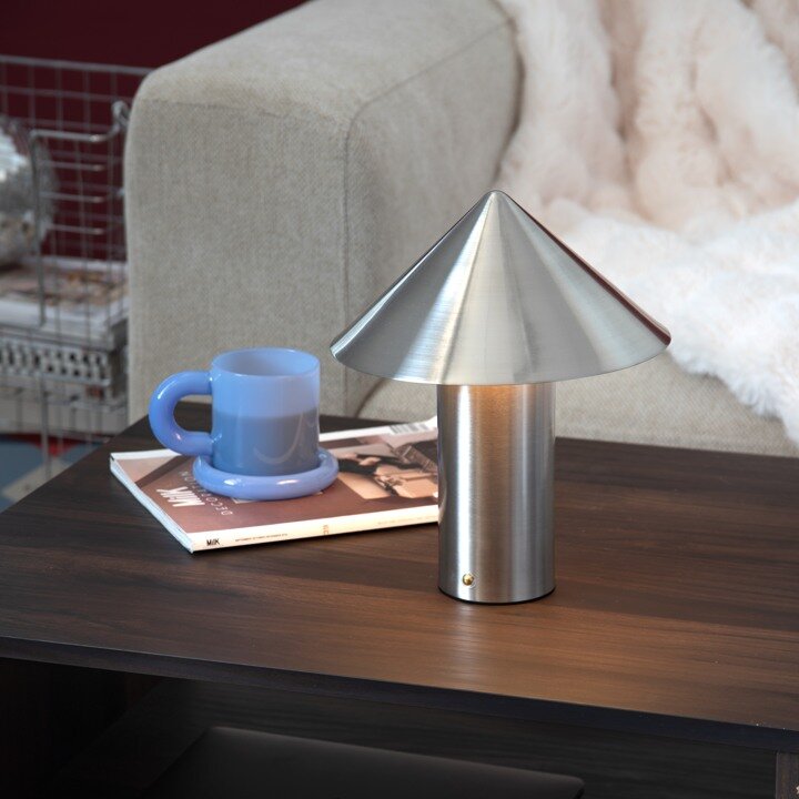 Metal table lamp on a side table as a gift for him.
