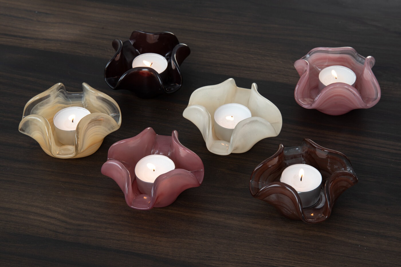 Glass tealight holders with lit candles as a gift for a friend.