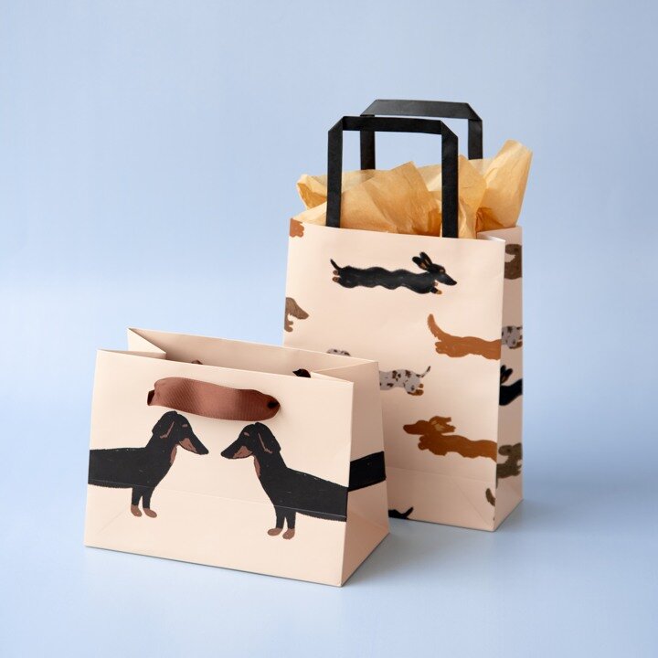 Gift bags with dachshund designs as inspiration for a gift for a colleague.