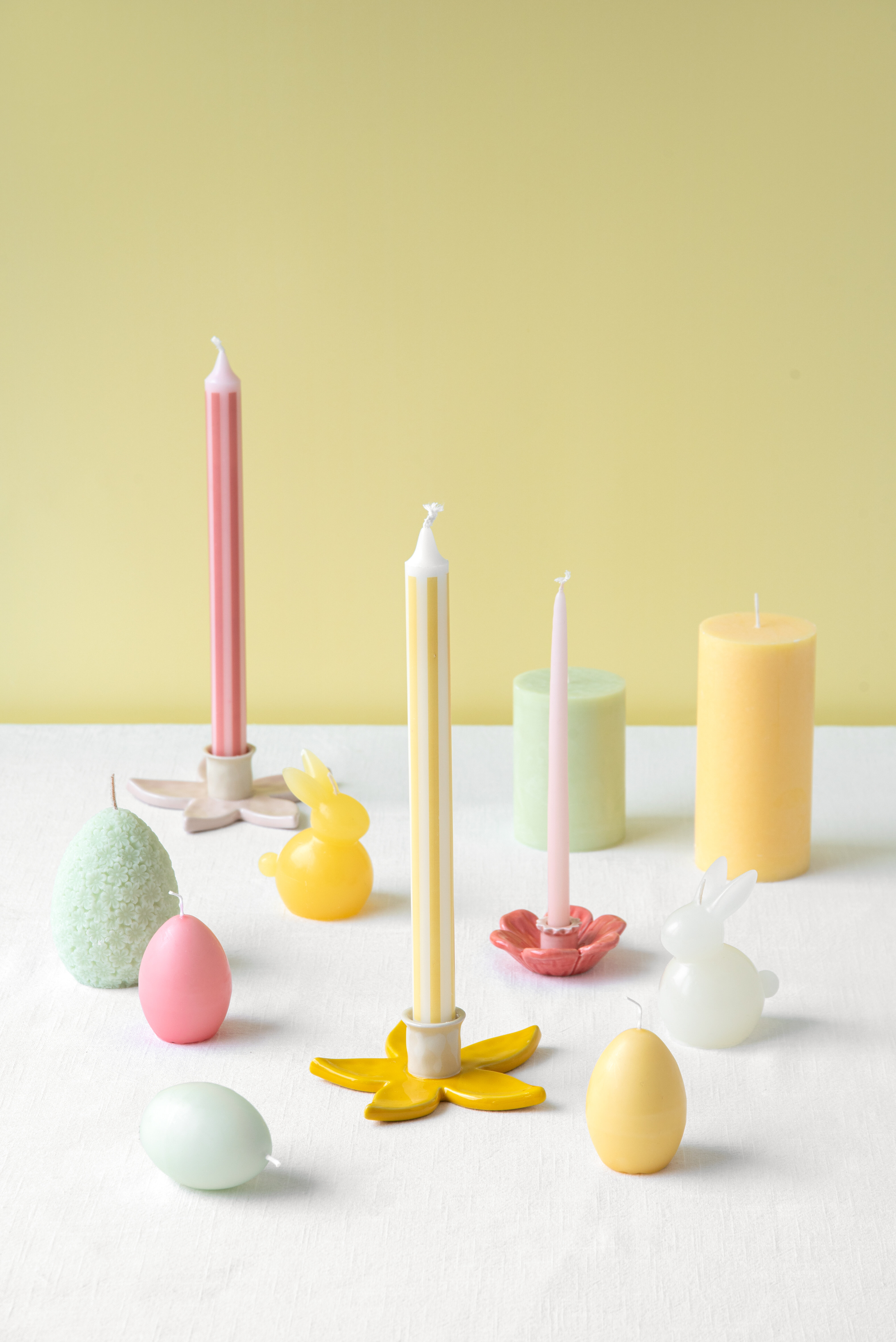 Easter candles in yellow and pink tones
