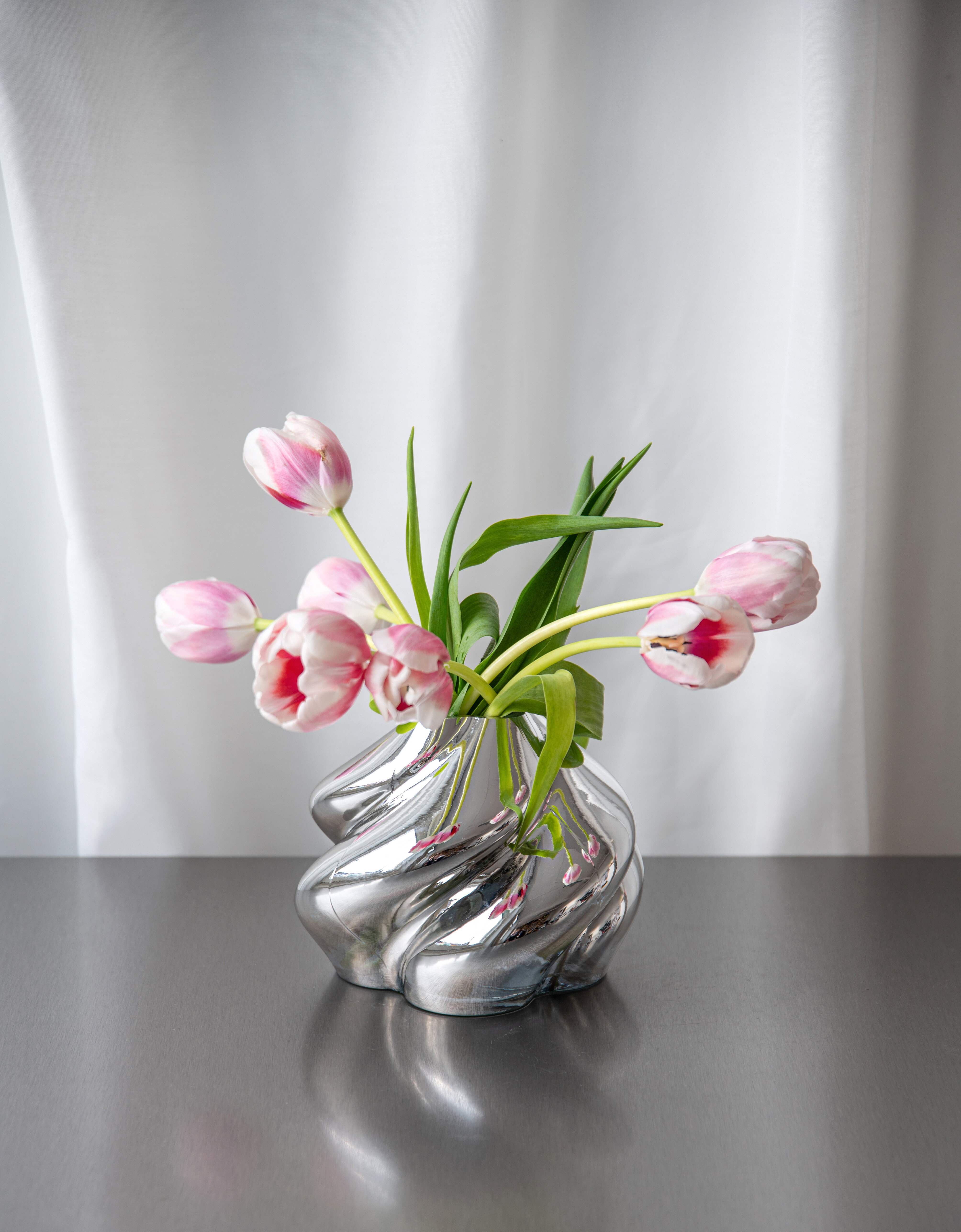 Silver-coloured vase with flowers
