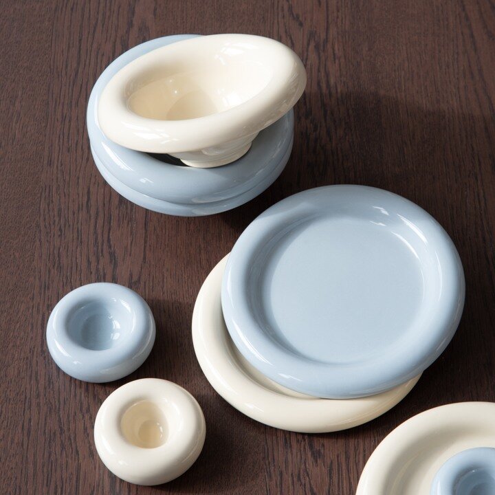 Blue and cream tableware on a wooden table.