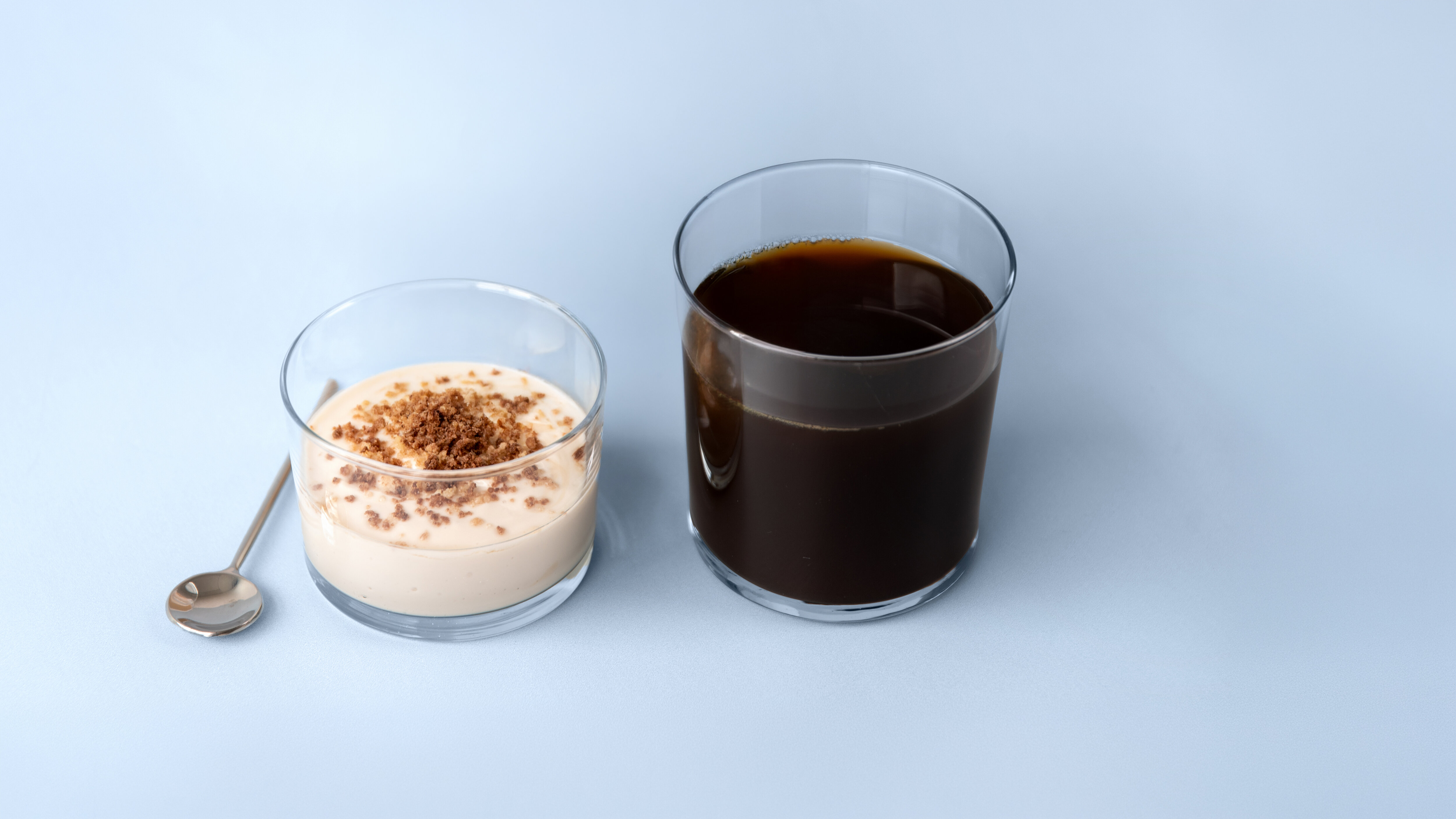 Two glasses with light blue background.