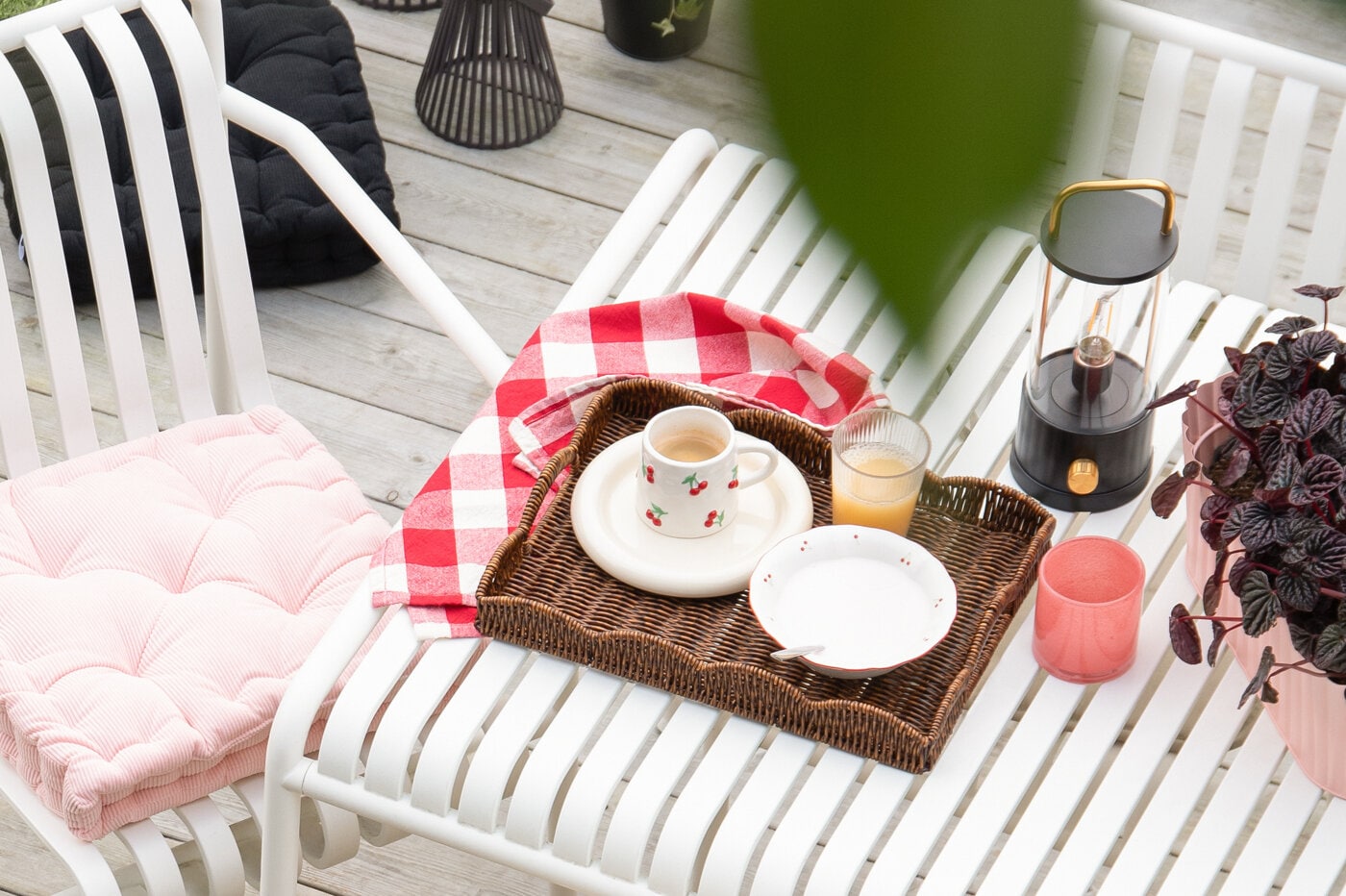 Tray with breakfast placed on a table outside.