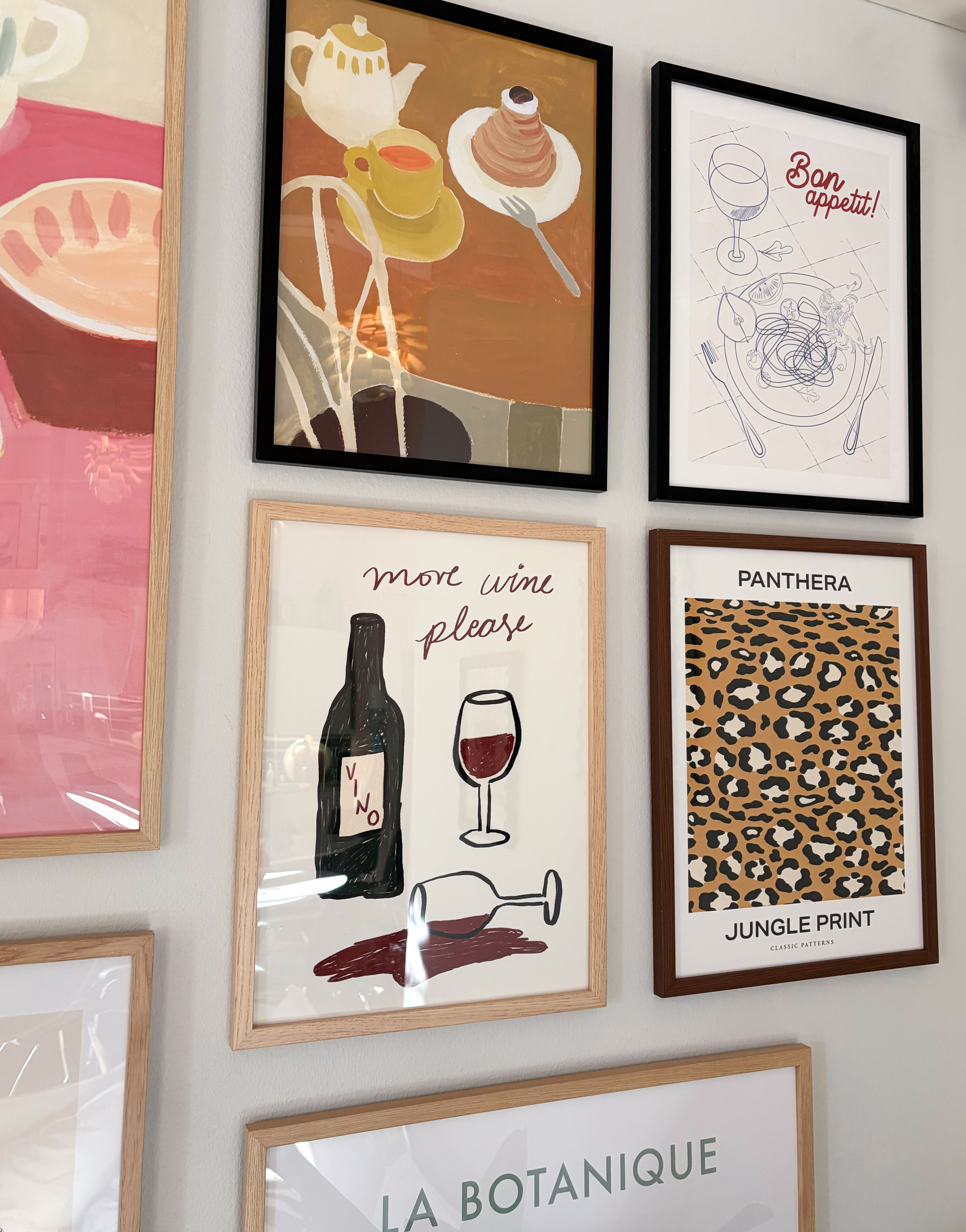 Gallery wall featuring framed art prints in various designs and colours.