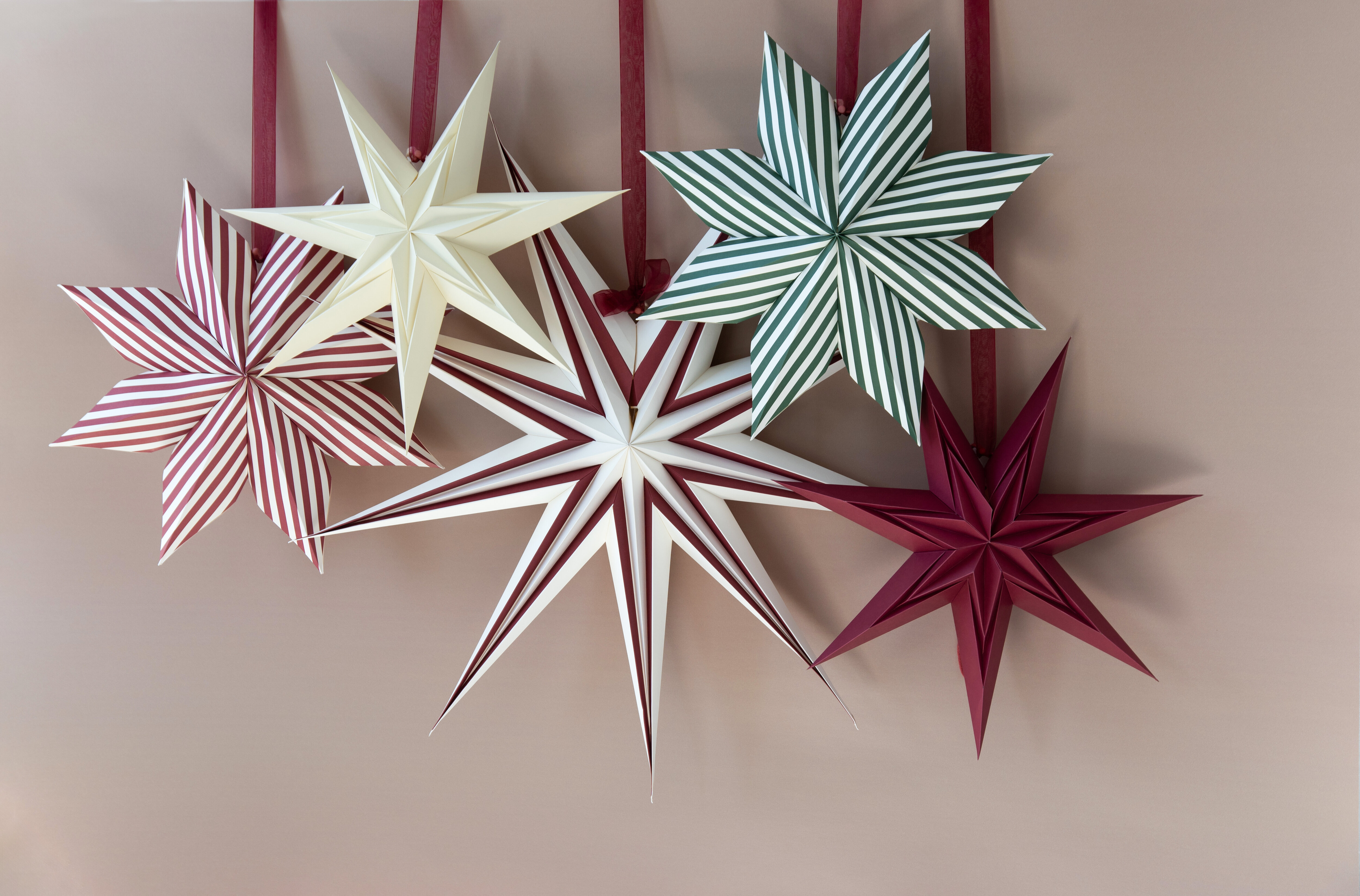 White and red paper stars glowing in a window.