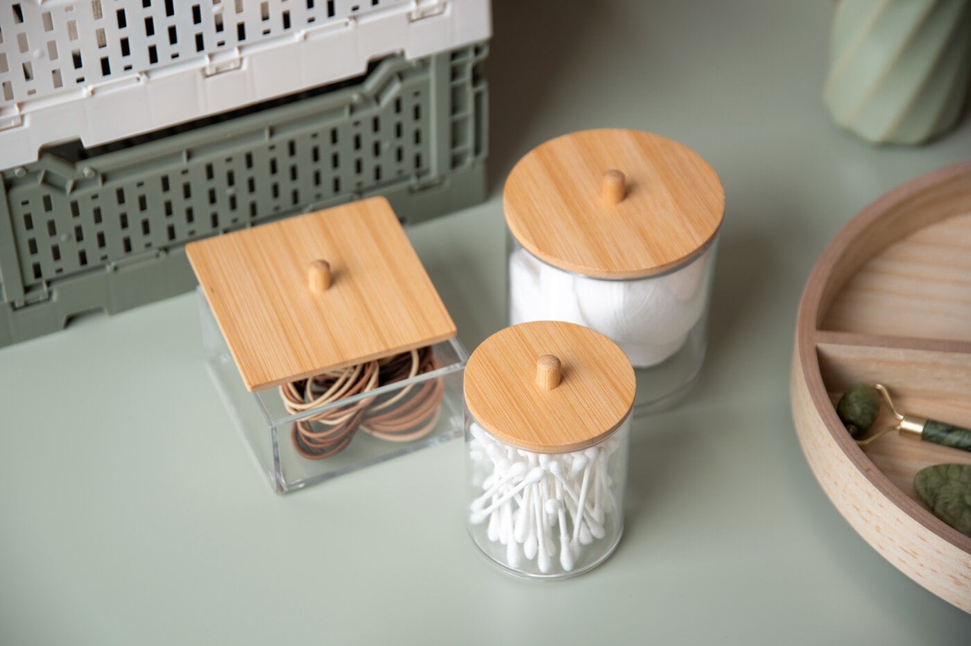 Small glass storage jars with lids.
