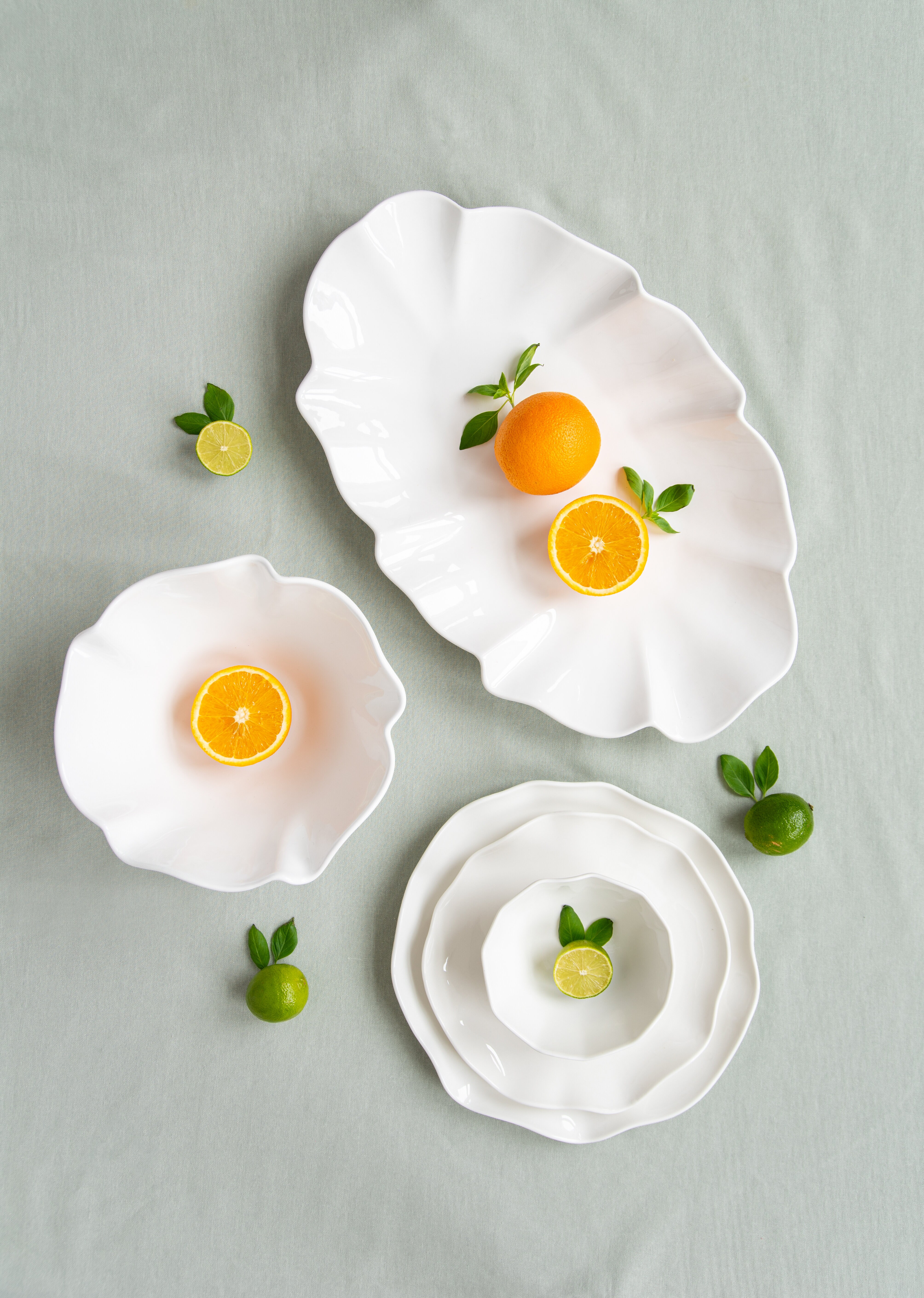 White porcelain with citrus fruits on it.