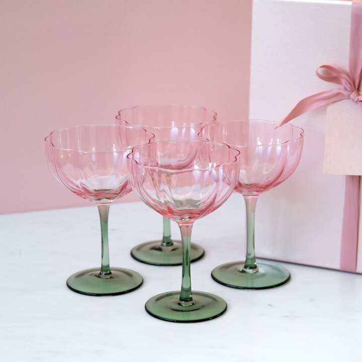 Pink wine glasses on a pastel background.