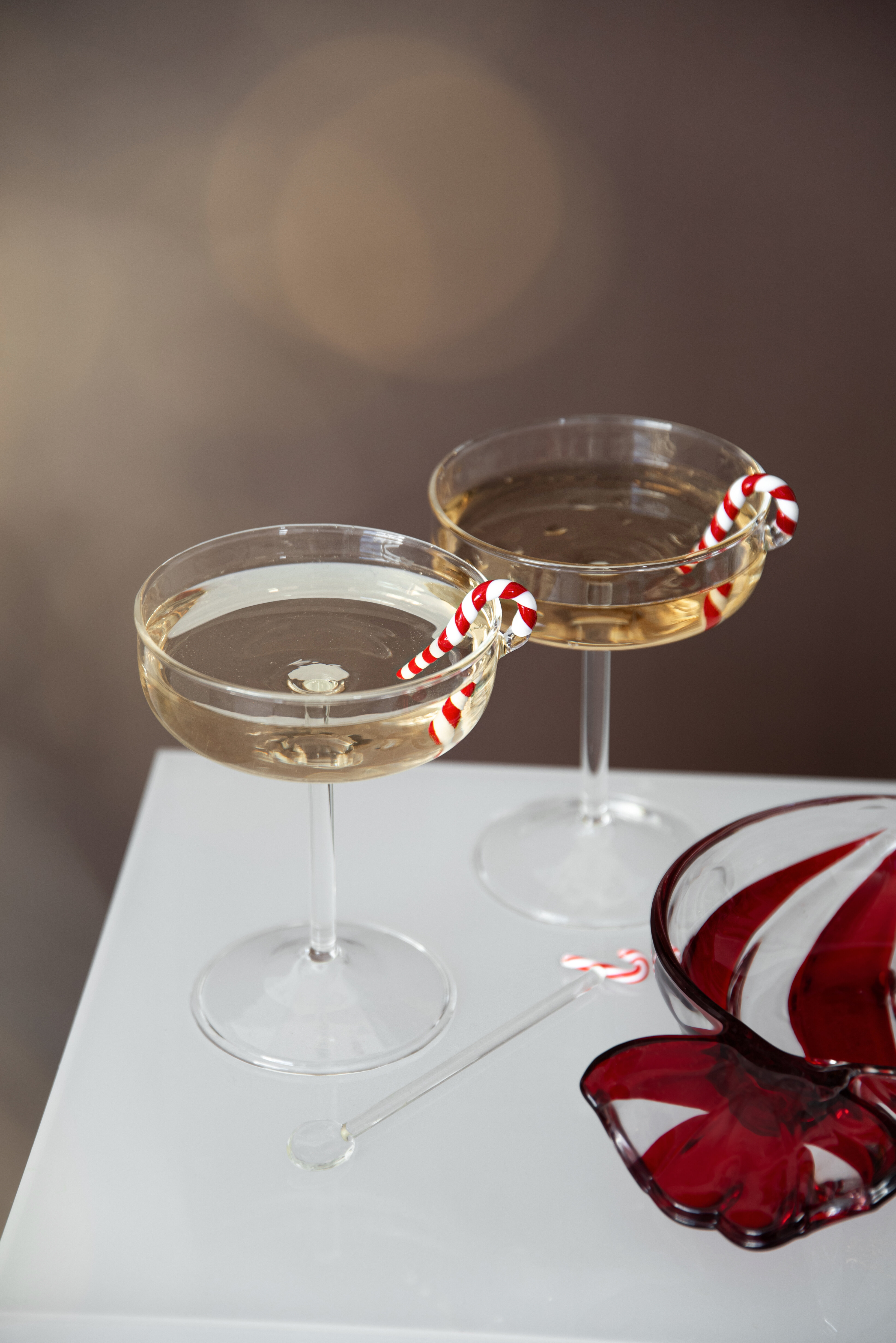 Festive cocktail glasses with candy canes.