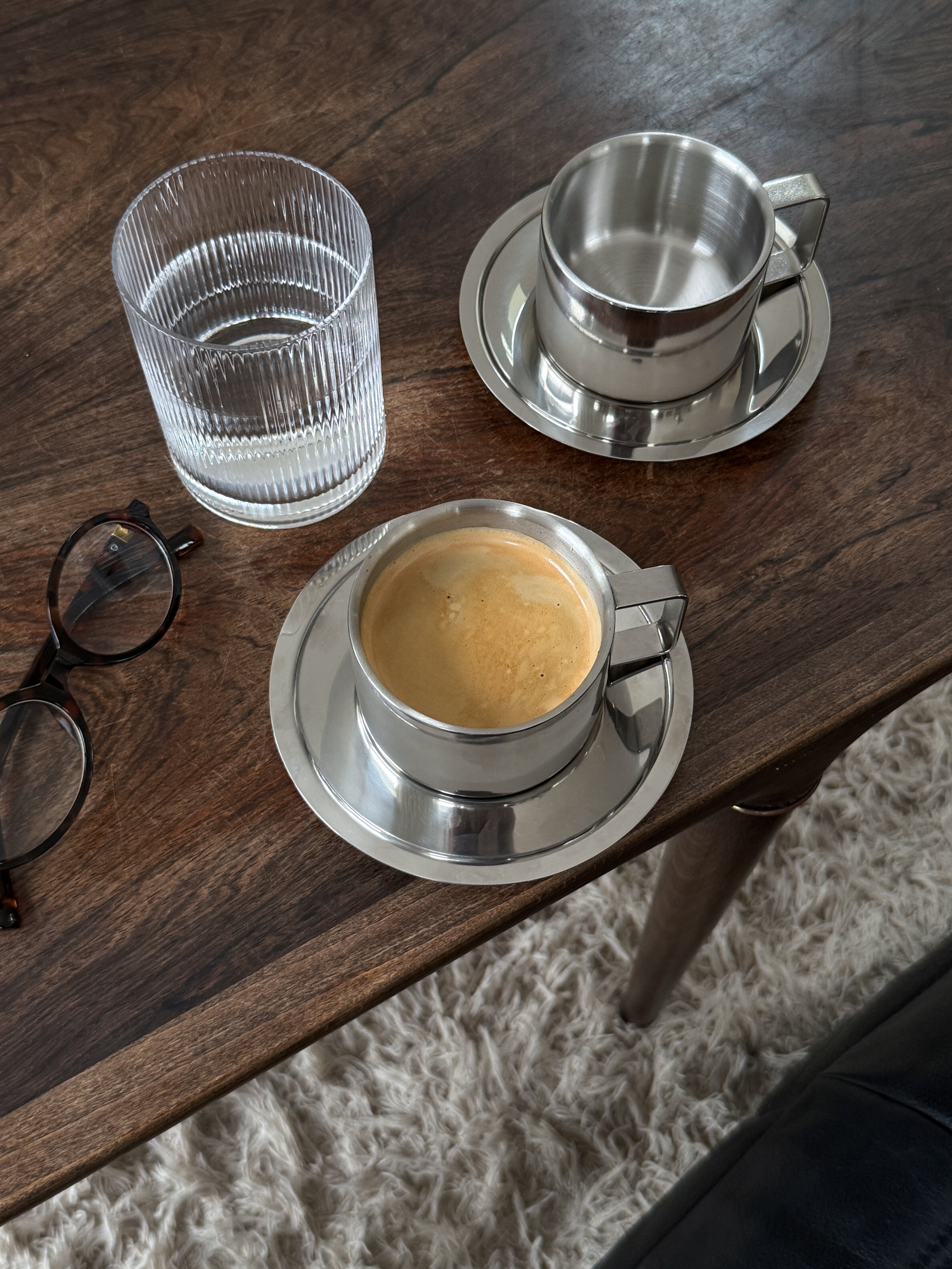 Coffee cup and glasses on a wooden table